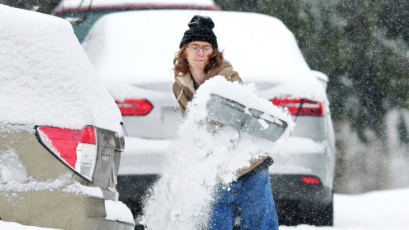 FILE -- A Pennsylvania resident shovels out their driveway as cold temperatures and snowfall...