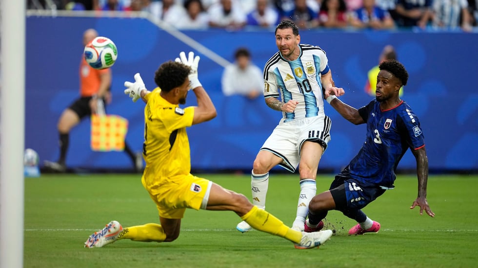 Argentina's Lionel Messi (10) scores their first goal against Cape Verde goalkeeper Vozinha...