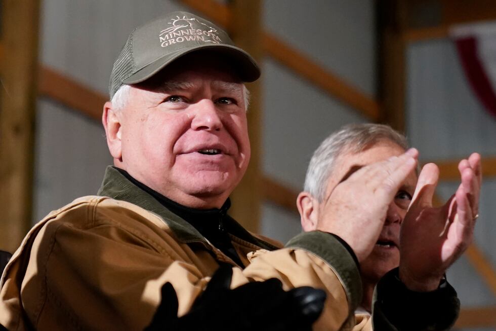 FILE - Minnesota Gov. Tim Walz applauds as President Joe Biden speaks at Dutch Creek Farms in...