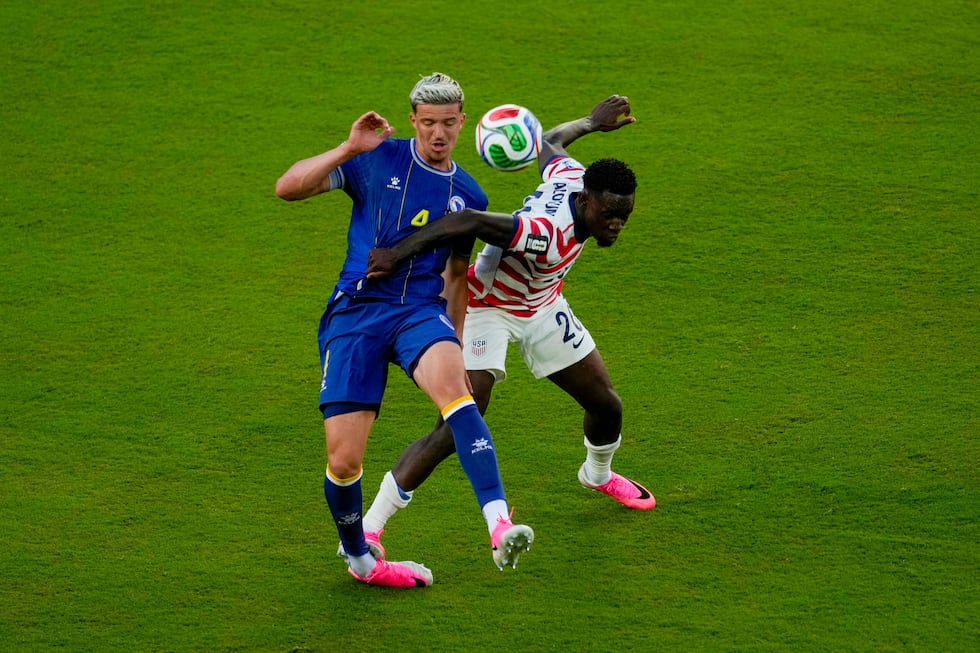 United States' Folarin Balogun (20) fouls Bosnia's Tarik Muharemovic (4) during the World Cup...