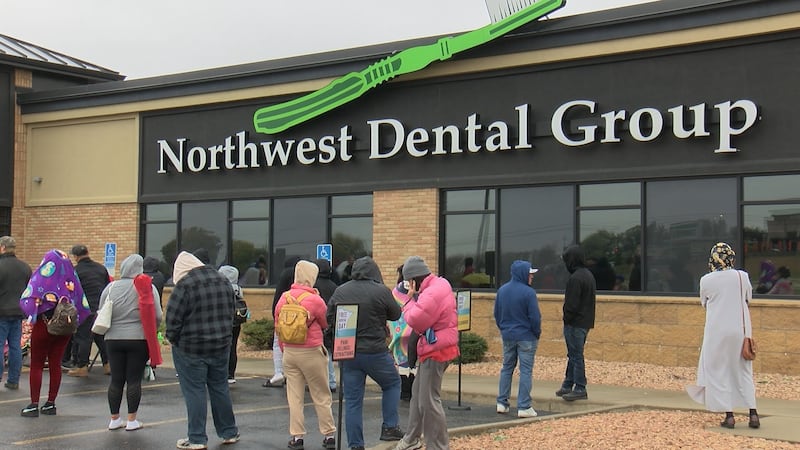 People wait to receive free dental care outside Northwest Dental Group.