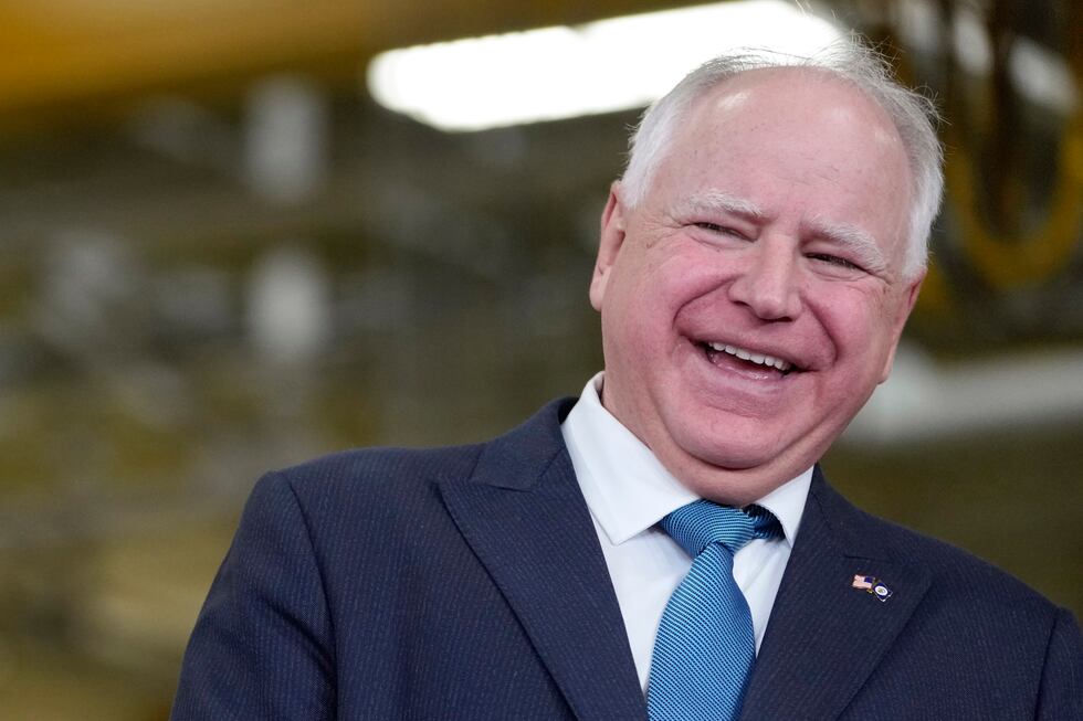 FILE - Minnesota Gov. Tim Walz, right, laughs as he stands with Fridley, Minn., Mayor Scott...