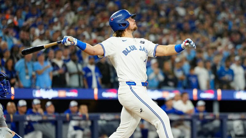 Toronto Blue Jays' Addison Barger watches his grand slam against the Los Angeles Dodgers...