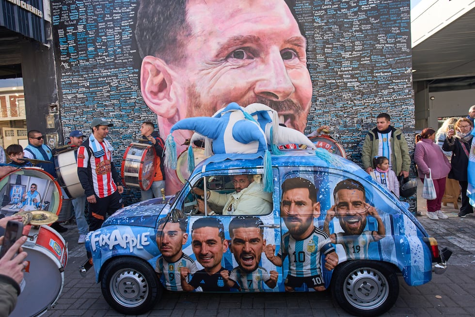 People gather to sing happy birthday to Lionel Messi at a street mural of him in Buenos Aires,...
