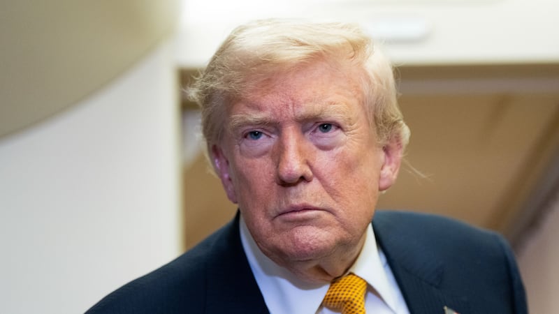 President Donald Trump speaks with reporters in flight on Air Force One after landing at U.S....